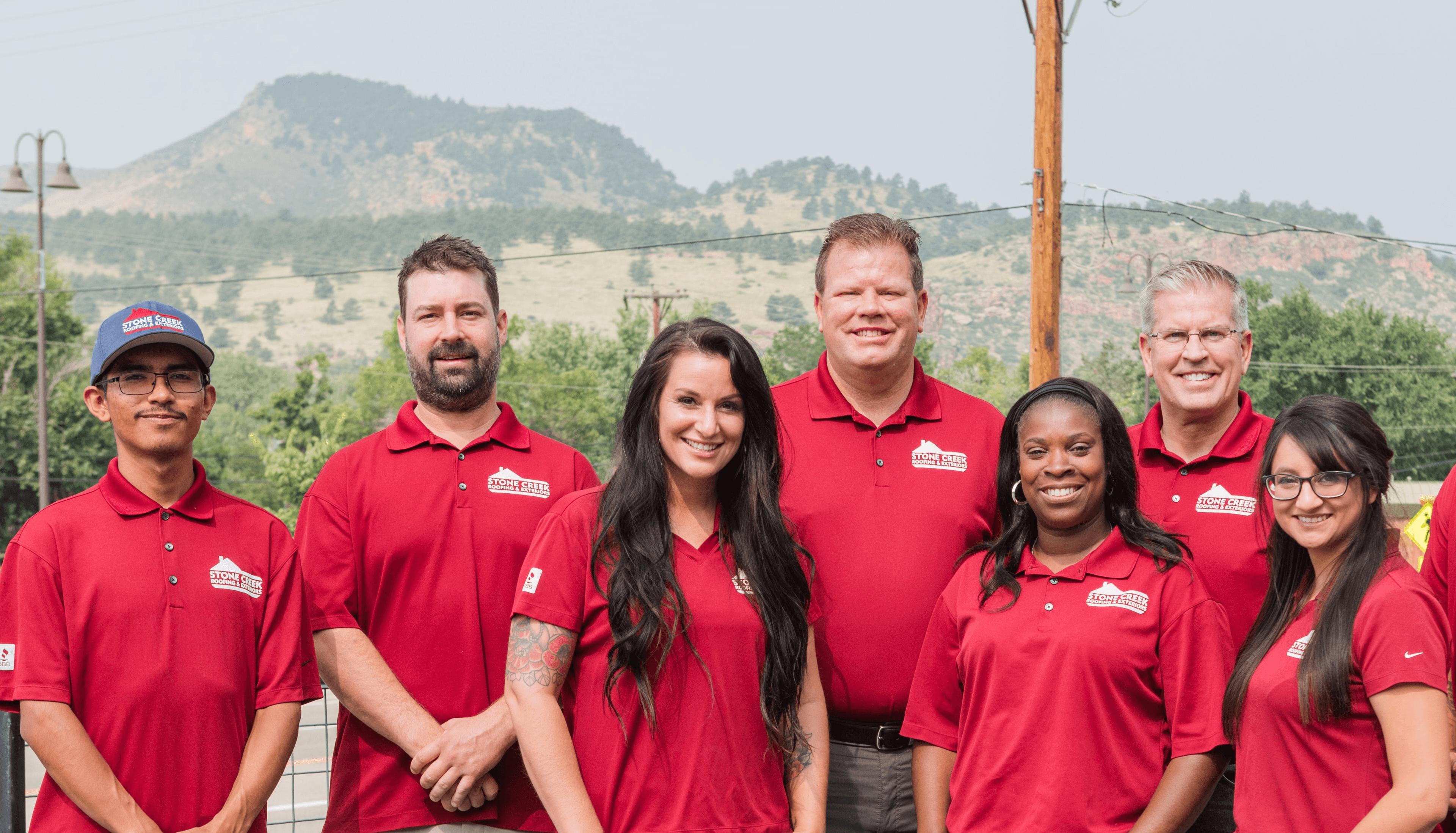 Roofing team in front of front range mountains