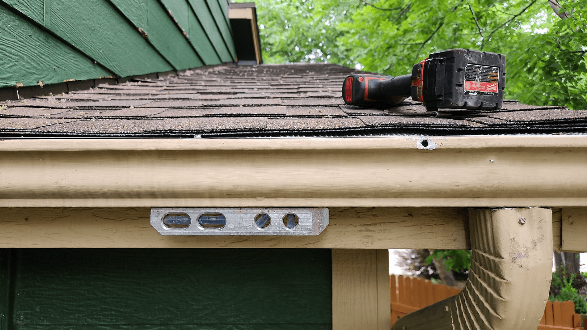 Screw driver on roof with gutters